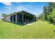 Screened patio with a view of the backyard and surrounding landscape at 16028 Golden Lakes Dr, Wimauma, FL 33598