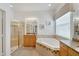 Relaxing bathroom with soaking tub, shower, and granite vanity at 16028 Golden Lakes Dr, Wimauma, FL 33598