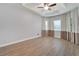 Bright bedroom featuring hardwood floors and neutral walls at 16028 Golden Lakes Dr, Wimauma, FL 33598