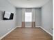 Well-lit bedroom with wood floors and neutral walls at 16028 Golden Lakes Dr, Wimauma, FL 33598