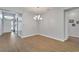 Light and airy dining room with hardwood floors and chandelier at 16028 Golden Lakes Dr, Wimauma, FL 33598