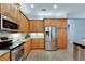 Kitchen with stainless steel appliances and wood cabinets at 16028 Golden Lakes Dr, Wimauma, FL 33598