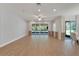 Bright living room featuring hardwood floors and sliding glass doors at 16028 Golden Lakes Dr, Wimauma, FL 33598