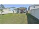 Screened patio and grassy backyard with white vinyl fence at 16942 Trite Bend St, Wimauma, FL 33598