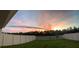 Backyard with sunset view and white vinyl fence at 16942 Trite Bend St, Wimauma, FL 33598