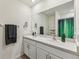 Double vanity bathroom with large mirror and shower at 16942 Trite Bend St, Wimauma, FL 33598