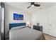 Bedroom with gray bedding, blue headboard, and city view art at 16942 Trite Bend St, Wimauma, FL 33598