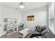 Bedroom with gray sofa, coffee table, and built-in shelving at 16942 Trite Bend St, Wimauma, FL 33598