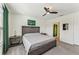 King-size bed in a well-lit bedroom with ensuite bathroom access at 16942 Trite Bend St, Wimauma, FL 33598