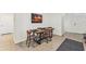 Simple dining area with a rustic wood table and four chairs at 16942 Trite Bend St, Wimauma, FL 33598