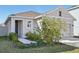 Inviting house exterior featuring a landscaped walkway and two-car garage at 16942 Trite Bend St, Wimauma, FL 33598