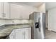 Sleek kitchen featuring stainless steel refrigerator and granite countertops at 16942 Trite Bend St, Wimauma, FL 33598