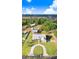 Expansive aerial view of a charming home with long driveway, lush landscaping, and screened pool at 1702 W Knights Griffin Rd, Plant City, FL 33565