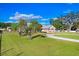 Property showing the large grass backyard and treelined views beyond the home's lot at 1702 W Knights Griffin Rd, Plant City, FL 33565