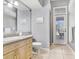 Well-lit bathroom with tile floors, granite countertops, and framed mirror at 1702 W Knights Griffin Rd, Plant City, FL 33565