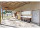 Wide view of the carport featuring rustic sink, storage, and access to backyard and a doorway at 1702 W Knights Griffin Rd, Plant City, FL 33565