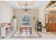 Light-filled dining area with tile flooring, window view, decorative shelving, and a charming chandelier at 1702 W Knights Griffin Rd, Plant City, FL 33565