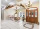 Bright foyer features tile flooring, decorative ceiling, and decorative wood and floral accents above the entry and dining area at 1702 W Knights Griffin Rd, Plant City, FL 33565