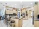 Bright kitchen with stainless steel appliances, pendant lighting, granite countertops and island seating at 1702 W Knights Griffin Rd, Plant City, FL 33565