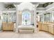 The bathroom is open and airy with a luxurious tub, double vanity, and columns adding architectural detail at 1702 W Knights Griffin Rd, Plant City, FL 33565