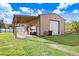 Exterior view of an outbuilding with an attached carport, providing ample covered storage at 1702 W Knights Griffin Rd, Plant City, FL 33565