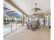 Relaxing covered lanai with a dining table and ceiling fans overlooking the screened-in pool area at 1702 W Knights Griffin Rd, Plant City, FL 33565