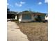 Ranch-style home with green shutters and a large yard at 1819 Grand Blvd, Holiday, FL 34690