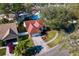 Aerial view of a home with a red roof, a well-kept lawn, and proximity to neighborhood amenities at 18529 Otterwood Ave, Tampa, FL 33647