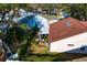 Aerial view of a home showcasing the backyard, enclosed patio, and the surrounding neighborhood at 18529 Otterwood Ave, Tampa, FL 33647