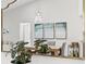 A dining room reflected in a mirror showcasing the table, chairs, artwork, and modern pendant lighting at 18529 Otterwood Ave, Tampa, FL 33647