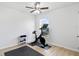 Bright exercise room with window view, stationary bike, weights and padded flooring at 18529 Otterwood Ave, Tampa, FL 33647