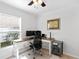 Bright home office features a large window, modern desk, ergonomic chair, and built-in storage at 18529 Otterwood Ave, Tampa, FL 33647