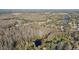 Aerial view of a neighborhood with a small lake and mature trees at 18615 Yocam Ave, Lutz, FL 33549