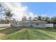 Large backyard with grassy area and a view of the house at 18615 Yocam Ave, Lutz, FL 33549