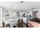 Open concept dining area with white farmhouse table and a sliding barn door at 18615 Yocam Ave, Lutz, FL 33549