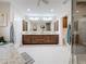 Bathroom featuring double vanities, tile flooring, and a glass-enclosed shower at 212 S Himes Ave, Tampa, FL 33609