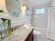 Bathroom with granite counters, vessel sink, and a shower-over-tub combination with subway tile surround at 212 S Himes Ave, Tampa, FL 33609