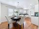 Bright dining area showcases an elegant chandelier and access to the kitchen at 212 S Himes Ave, Tampa, FL 33609