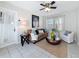 Bright living room with a cozy sofa, ceiling fan, and tile floors at 212 S Himes Ave, Tampa, FL 33609