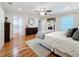 Spacious bedroom with hardwood floors, a ceiling fan, and a walk-in closet at 212 S Himes Ave, Tampa, FL 33609