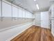 Spacious closet with hardwood floors, adjustable shelving, and a separate built-in shelf unit for optimal storage at 212 S Himes Ave, Tampa, FL 33609