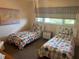 Two twin beds in a bright and airy bedroom at 2263 Americus E Blvd # 59, Clearwater, FL 33763