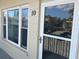 Condo entrance with a glass storm door and large windows at 2263 Americus E Blvd # 59, Clearwater, FL 33763