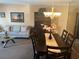 Cozy living room featuring neutral toned walls and decor, wooden dining table, and complementary furniture at 2263 Americus E Blvd # 59, Clearwater, FL 33763