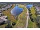 Aerial view of community with golf course, lake, and homes at 2416 Kensington Greens Dr # 2416, Sun City Center, FL 33573