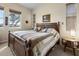 King-size bed with plaid comforter and nightstand in bedroom at 2416 Kensington Greens Dr # 2416, Sun City Center, FL 33573