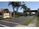 Kings Point community entrance with palm trees and guardhouse at 2416 Kensington Greens Dr # 2416, Sun City Center, FL 33573