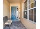 Bright entryway with teal door, decorative bench, and large windows at 2416 Kensington Greens Dr # 2416, Sun City Center, FL 33573