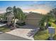 Tan house with two-car garage and landscaped yard at 2416 Kensington Greens Dr # 2416, Sun City Center, FL 33573