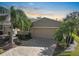 Tan house with two-car garage and landscaped yard at 2416 Kensington Greens Dr # 2416, Sun City Center, FL 33573